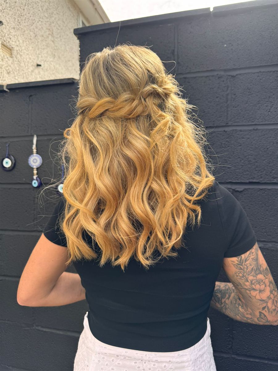 Boho twisted half-up style with tumbling golden waves