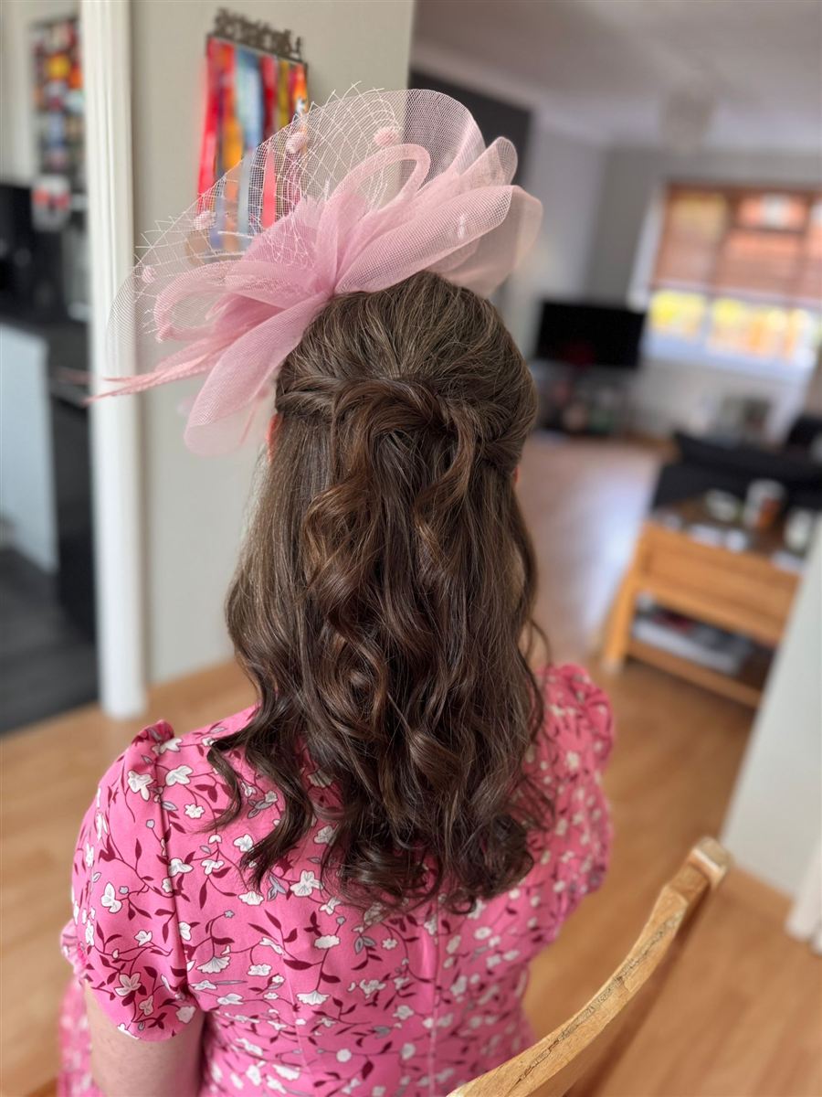 Event half-up style with pink fascinator