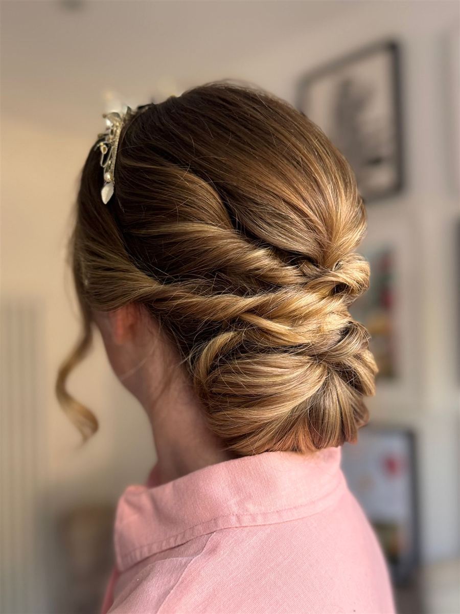 Elegant twisted low chignon updo with delicate hair accessory