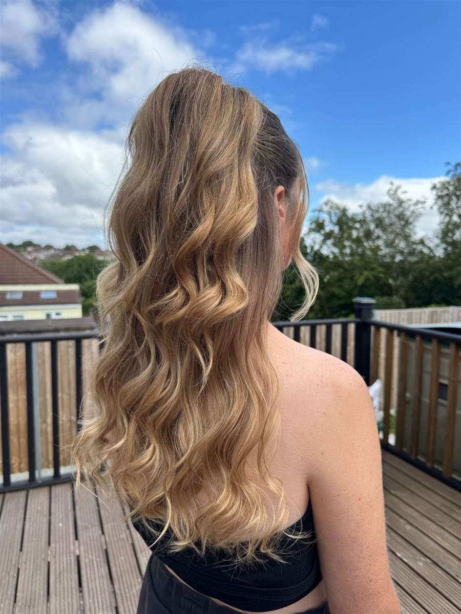 High half-up ponytail with long glamorous waves